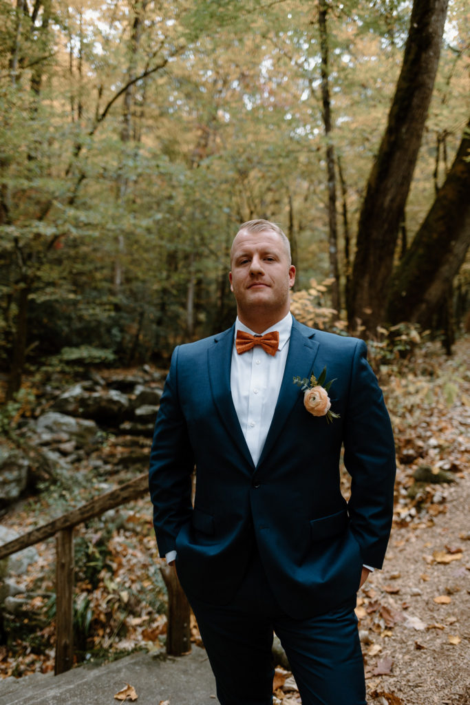 I love the classy blue suit paired with orange accents. This combo is great for summer or fall elopement outfits.