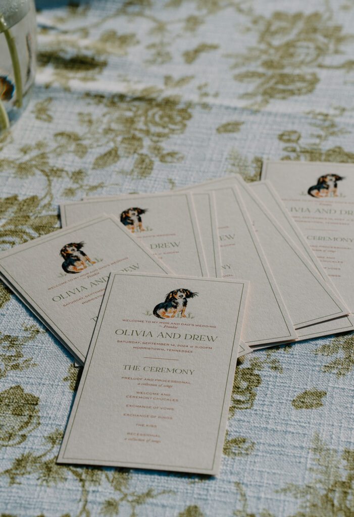Personalized wedding itinerary cards for guests at colorful summer garden wedding.