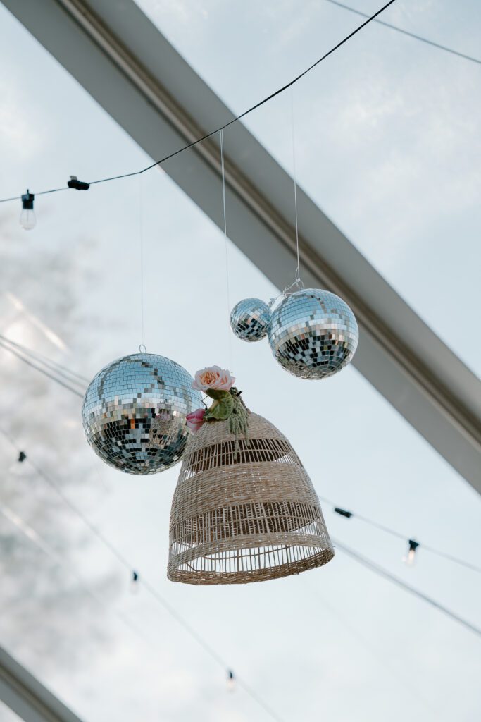 Reception disco ball details for modern backyard tent wedding.
