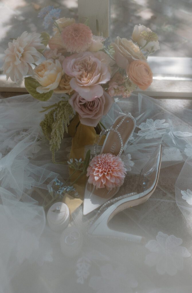 Artistic bridal details with classy bridal shoes and colorful summer wedding bouqet. 