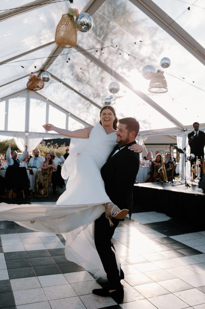 Bride and groom elegant and fun first dance photo.
