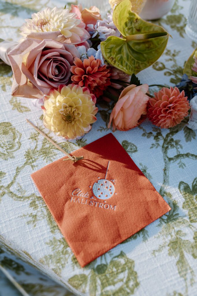 Custom made wedding reception napkin ideas at colorful backyard wedding.