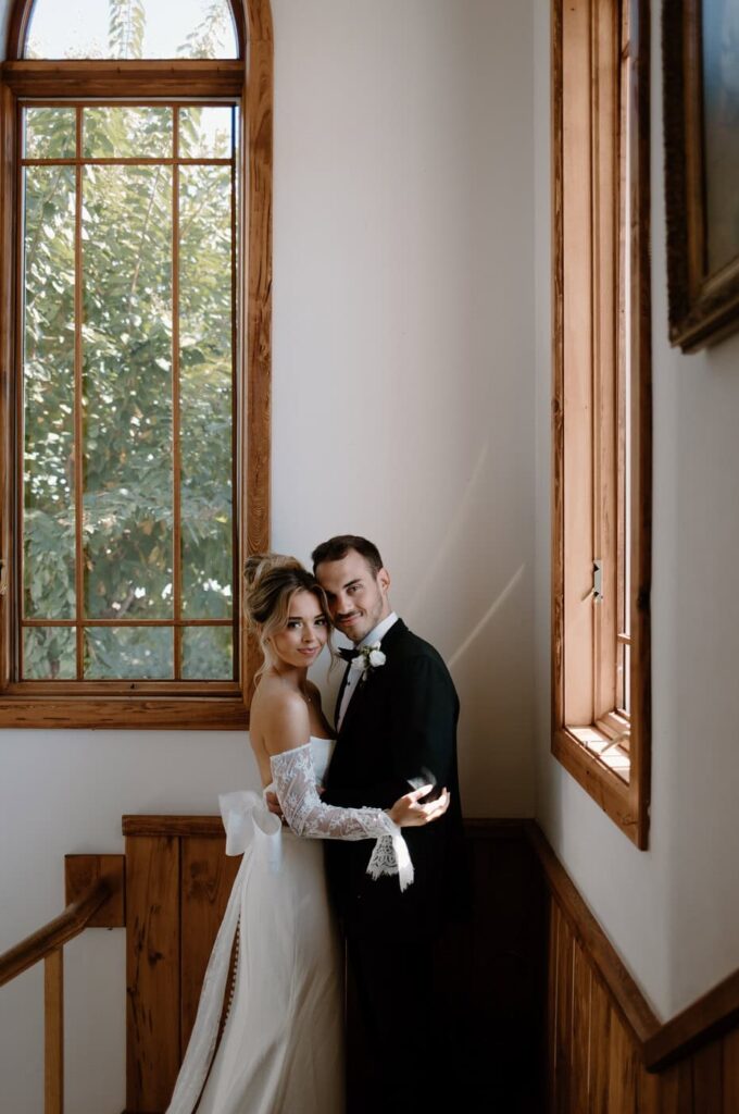 Classic wedding portrait of the bride and groom hugging inside in the chapel at Whitestone Inn, an east Tennessee wedding venue.