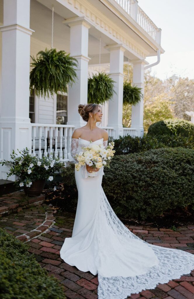 Classic bride stands in front of Whitestone Inn, an east Tennessee wedding venue full of southern charm and character.