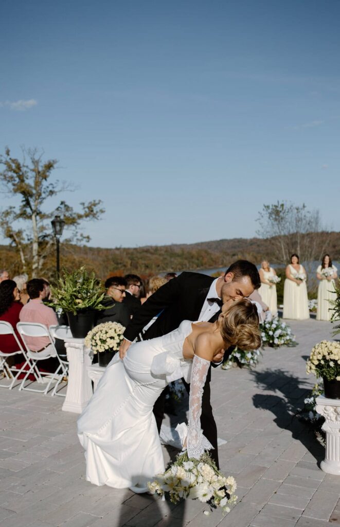 Bride and groom show off their dip kiss as the recess down the aisle during their wedding at Whitestone Inn, an east Tennessee wedding venue.