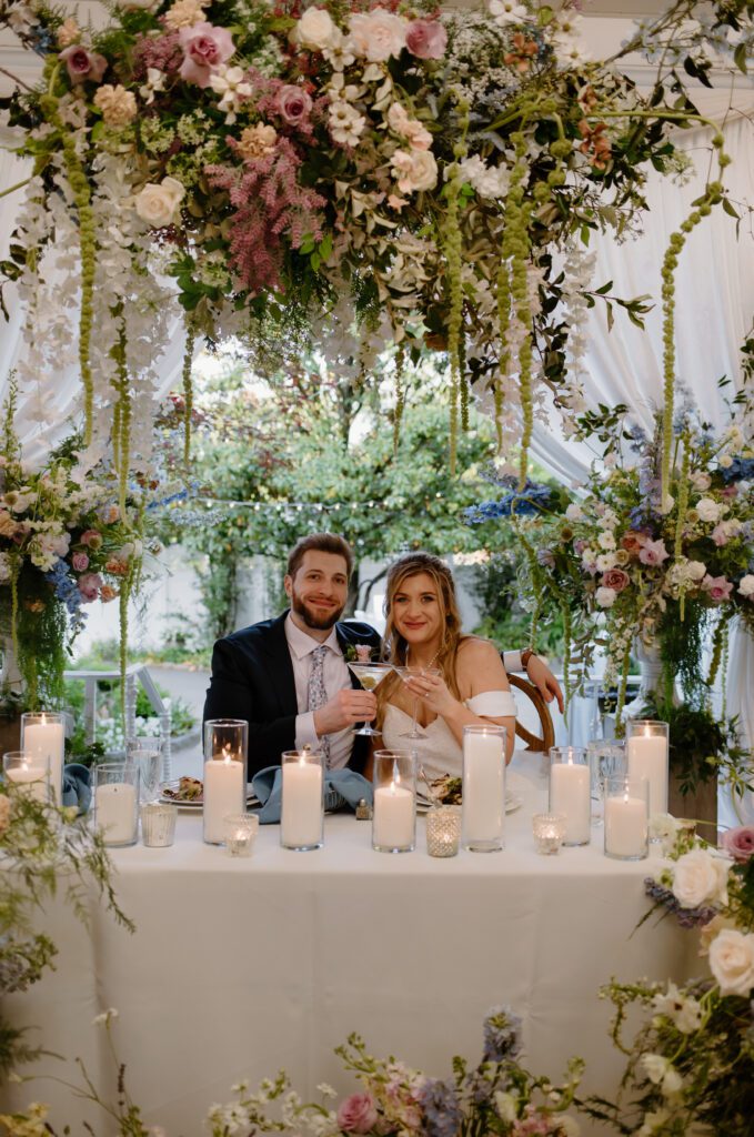 Stunning wildflower installment over sweetheart table at CJ's Off the Square, a Nashville outdoor wedding venue.