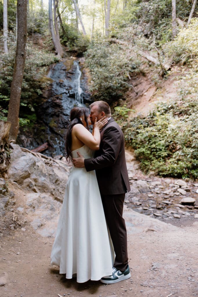 First kiss at Cataract Falls. Summer elopement in the Smokies.