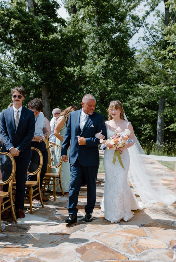 Bride walking down the aisle at The Garden Nichols Heir Summer Garden Wedding in Sevierville, TN