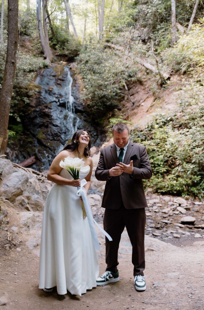 Couple soak in that 'just married' feeling as they look an their rings and family. Captured by Tennessee elopement photographer.