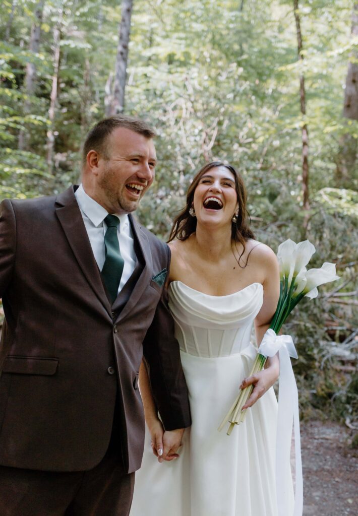Bride and groom laugh together as they walk through the national park, soaking in all the love and joy. Captured by Tennessee elopement photographer.