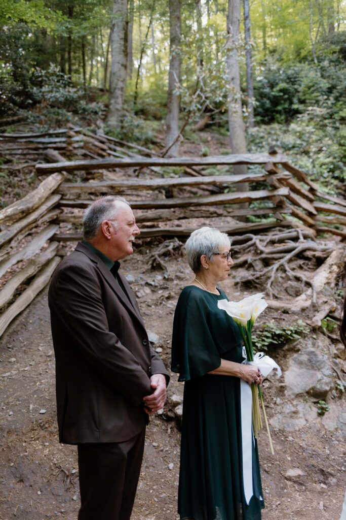 Parents watch as their daughter gets married at Cataract Falls in the Smoky Mountain National Park.