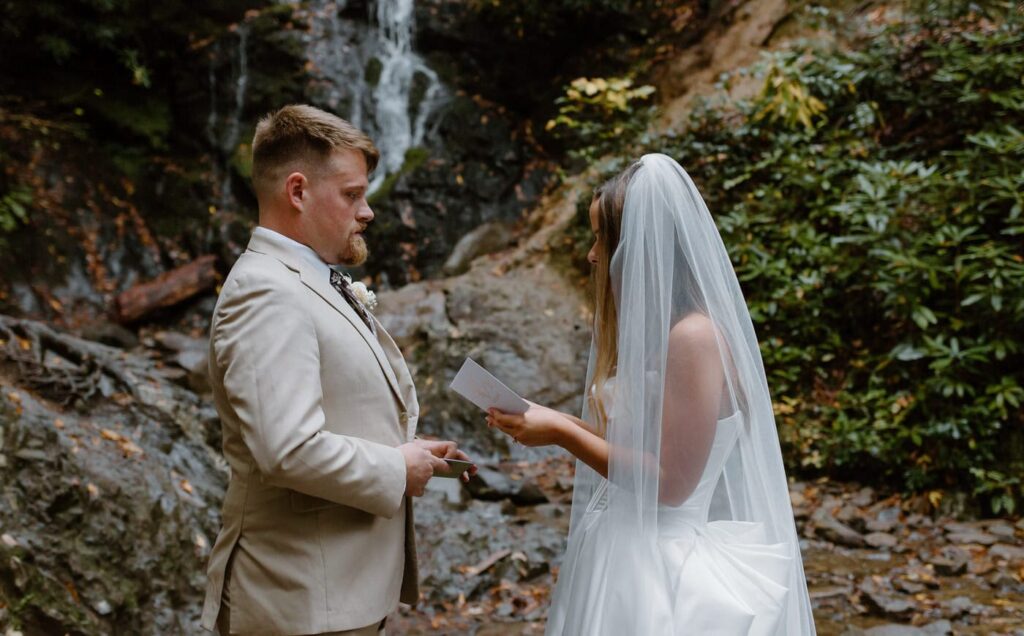 Couple share private vows beneath Cataract Falls for the Great Smoky Mountain elopement.