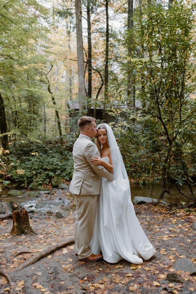 Couple poses near a small stream during their Great Smoky Mountain elopement.