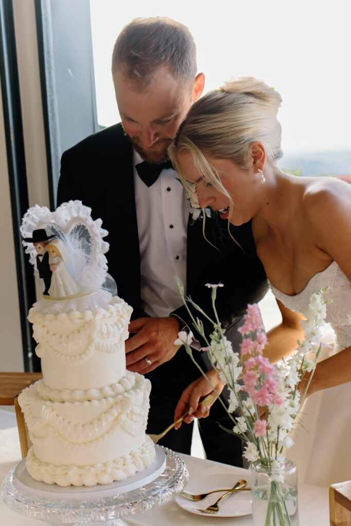 Bride and groom cutting their cake at Tennessee wedding venue, The Loyston.