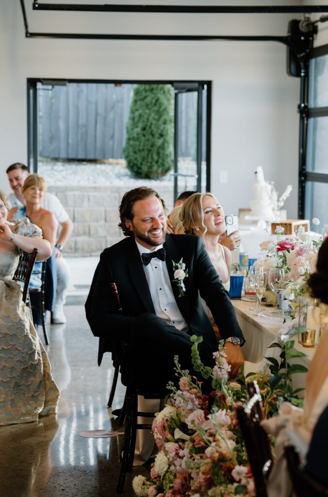 Candid moment of guests during wedding speeches at Tennessee wedding venue, The Loyston.