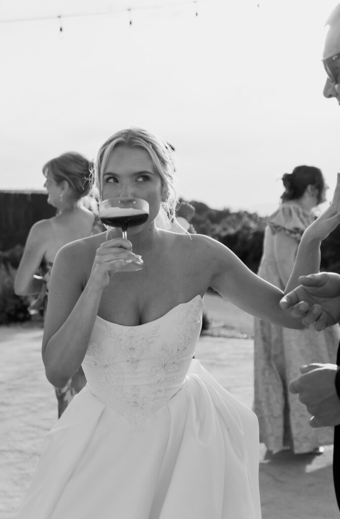 Fun wedding reception photo of the bride enjoying her drink at Tennessee wedding venue, The Loyston.