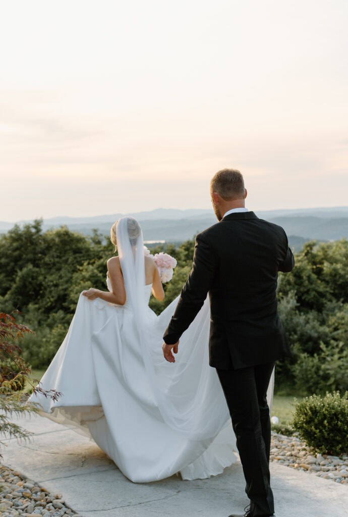 Candid moment of bride and groom walking together at Tennessee wedding venue, The Loyston.