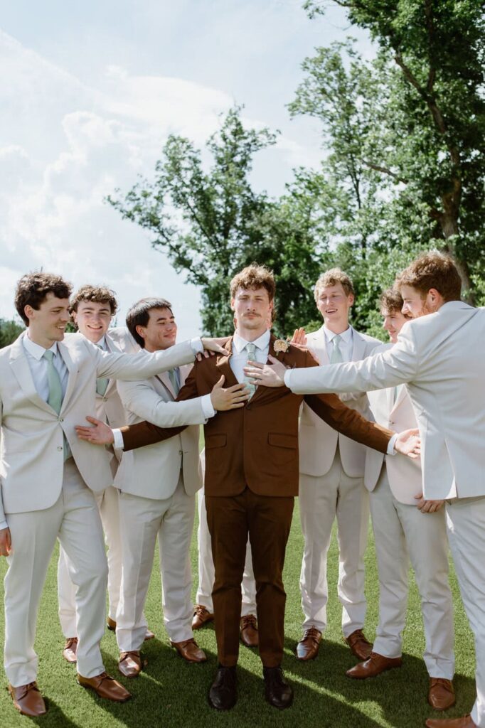 Personality shot of the groom and his groomsmen in brown and cream suits for a summer wedding in Tennessee.