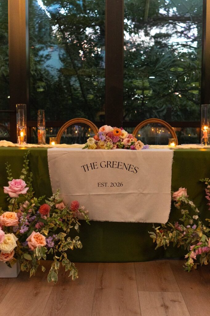 Nighttime capture of the sweetheart table at the wedding reception. 