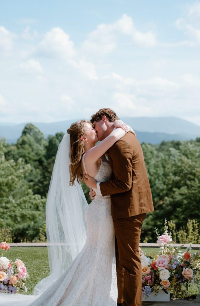 Bride and groom share their first kiss at The Garden ceremony site at Nichols Heir wedding venue in Tennessee.