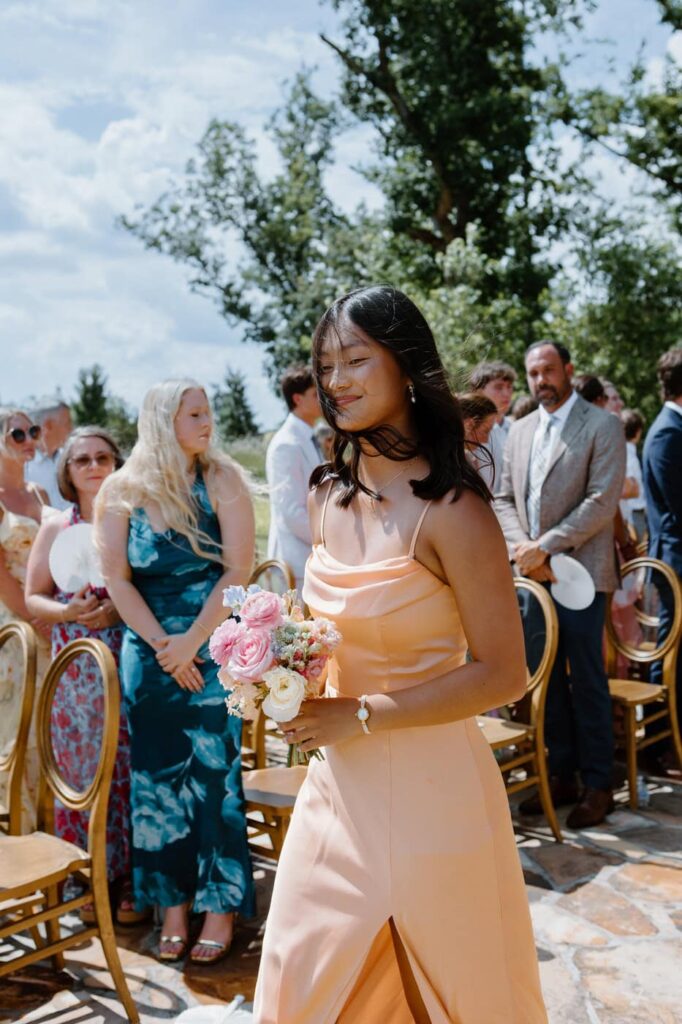 Pastel orange bridesmaids dress.