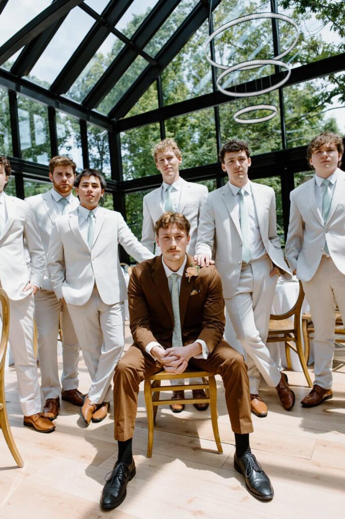Editorial inspired portrait of the groom and his groomsmen in the Glass House at Nichols Heir.