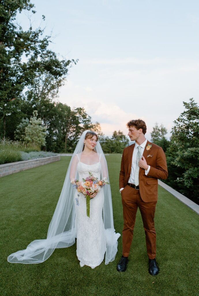 Bride and groom pose for portraits at their summer garden wedding at Nichols Heir wedding venue in Tennessee.