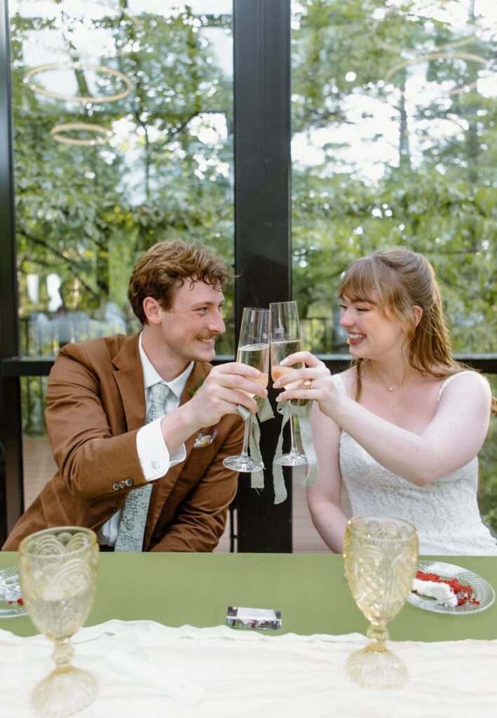Bride and groom cheers during their reception dinner at Nichols Heir wedding venue in Tennessee.