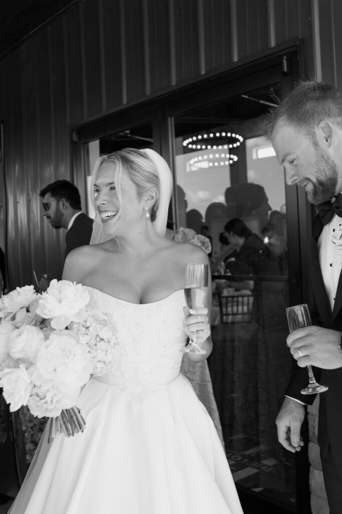 Candid moment of the bride and groom as they greet their guests during cocktail hour at The Loyston Wedding Venue in Tennessee.