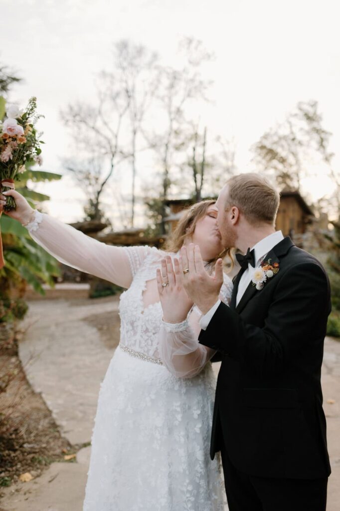 Bride and groom show off their wedding rings at Ancient Lore Village, Knoxville wedding venue.
