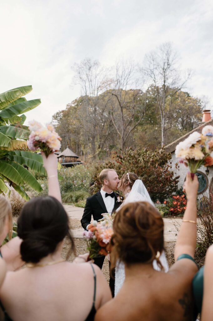 Creative bridal party photo of friends celebrating the bride and groom at Ancient Lore Village, Knoxville wedding venue.