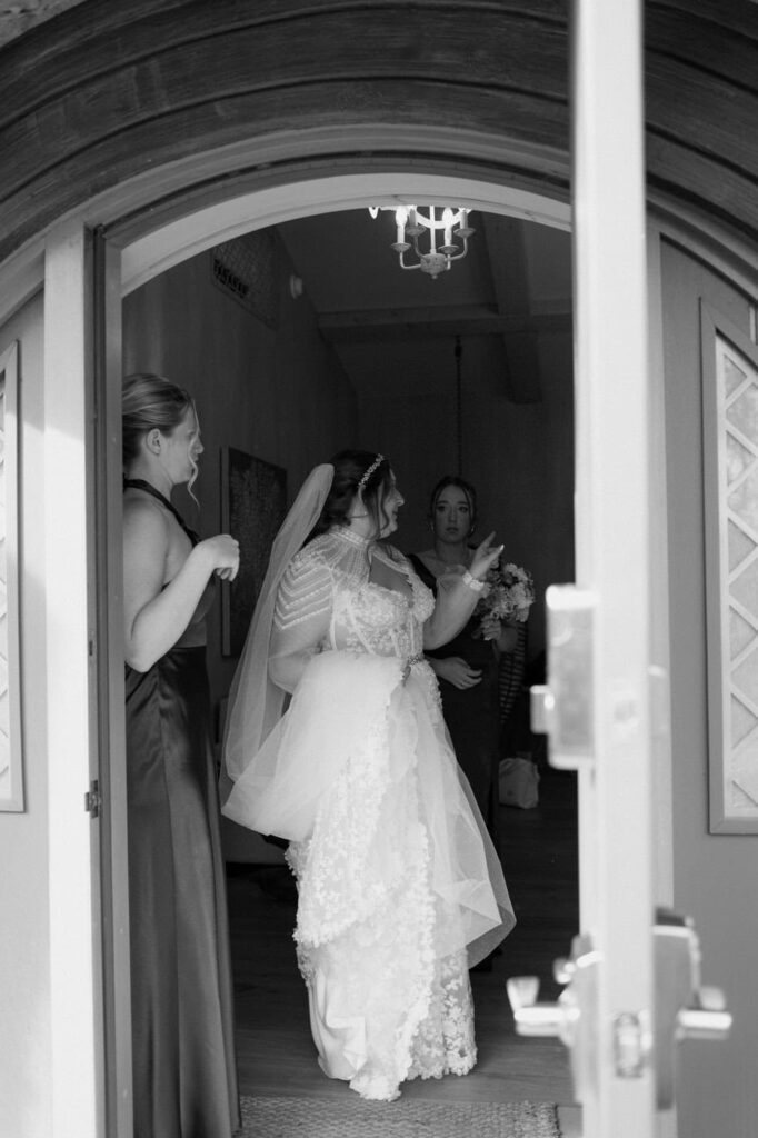 Through documentary photographer, I capture the in between moments to tell the story of your day from getting ready to the grand exit. I love this moment of the bride headed out the door with her bridesmaids at Knoxville wedding venue, Ancient Lore Village.
