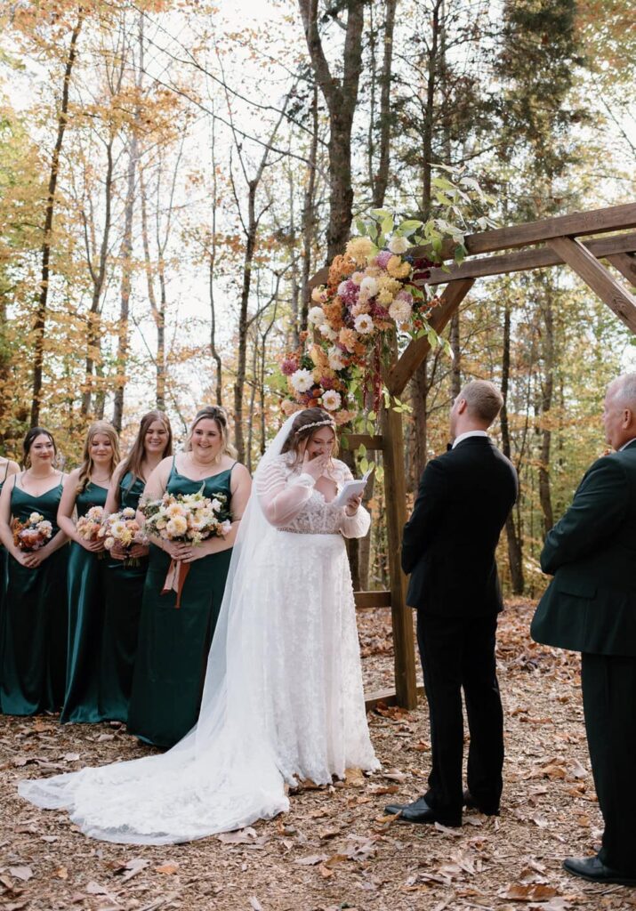 Bride shares emotional vows at fall wedding ceremony at Ancient Lore Village, Knoxville wedding venue.