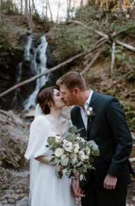 Bride and groom celebrate their marriage at Cataract Falls for their forest elopement. 