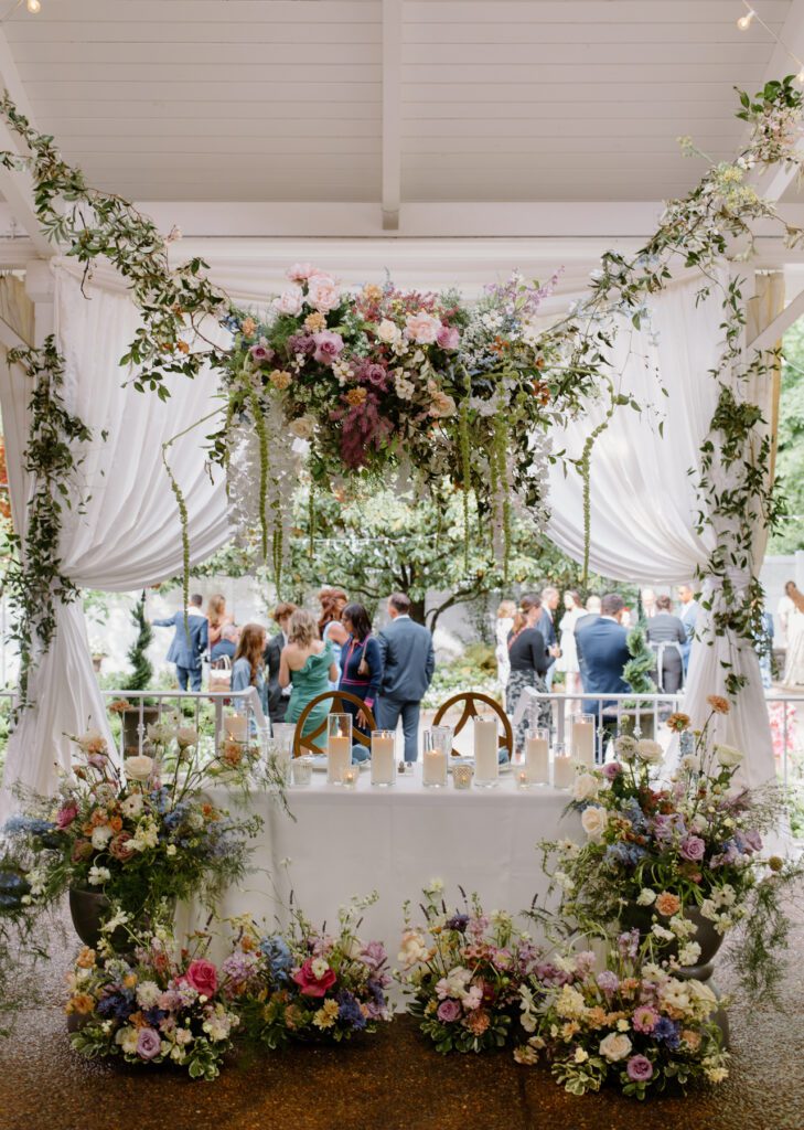 Gorgeous wildflower installment over sweetheart table for the reception at CJ's Off the Square, a Nashville wedding venue.
